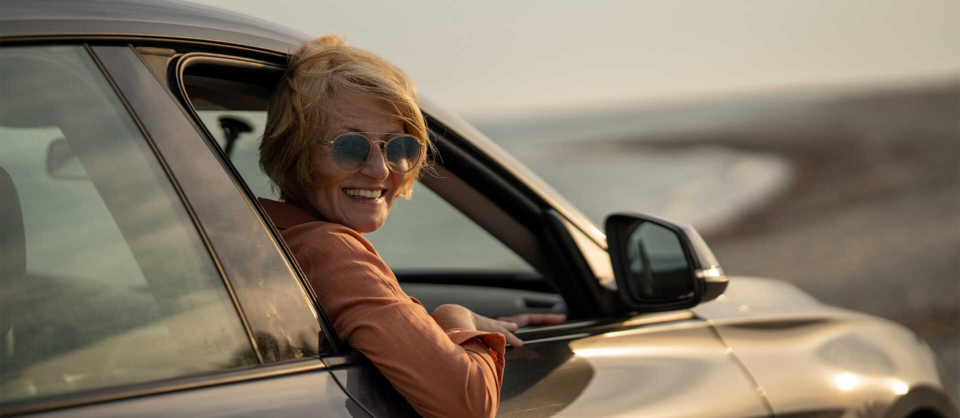 Vrouw leunt uit autoraam